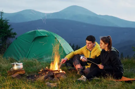classical-marshmallow-making-near-campfire-young-couple-majestic-